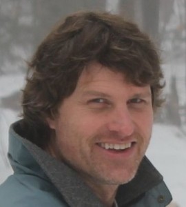 A man with brown hair and wearing a jacket.